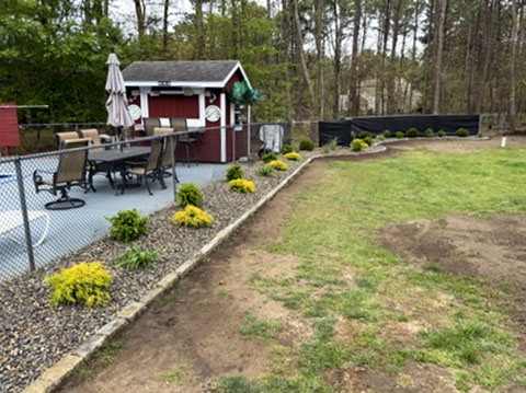 Poolside landscape beds with colorful shrubs and decorative stone